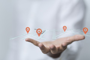 map pins floating above hand