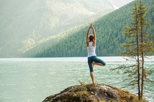 Woman Doing Yoga In Front Of A Lake