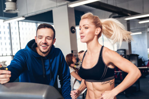 Gym woman exercising with her personal trainer
