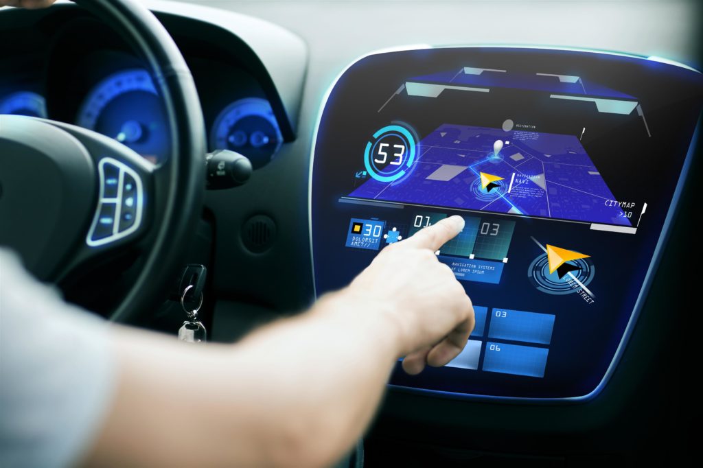 Man's hand using GPS navigation in car