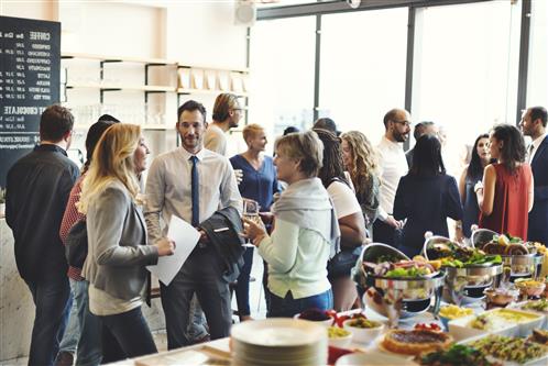 Mixed group of business people at networking buffet