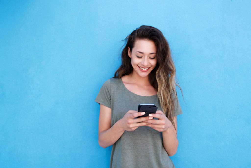 Woman Smiling Having a Good Mobile User Experience