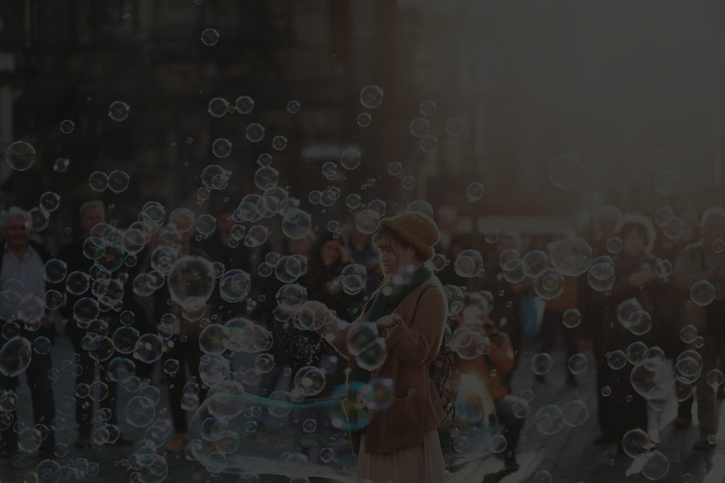 woman playing in bubbles black banner