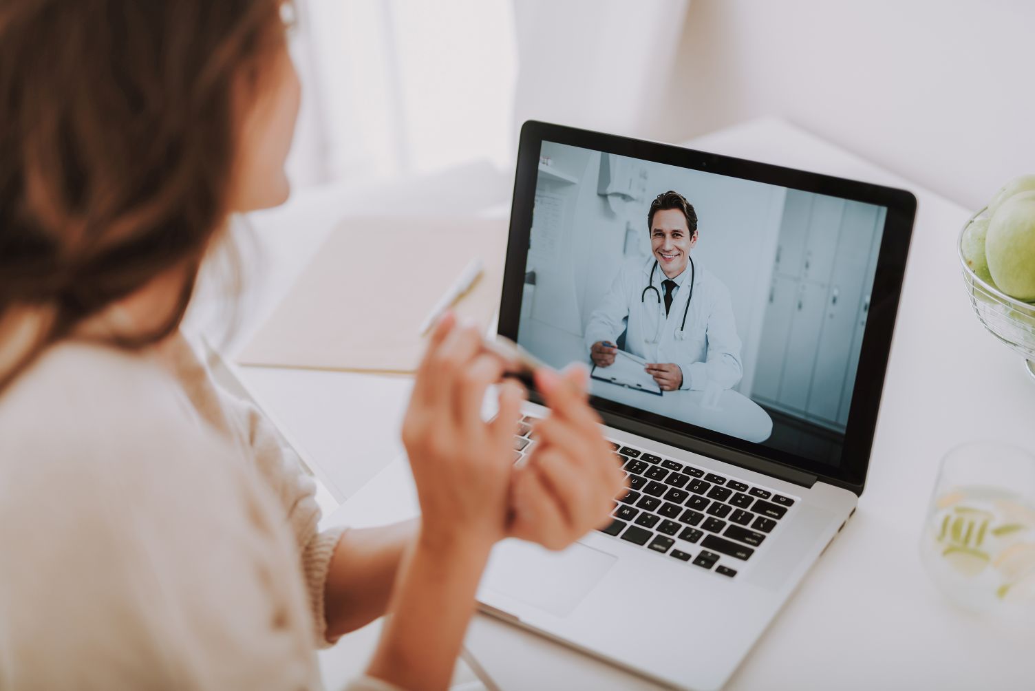 woman having a video chat call with her doctor about covid-19