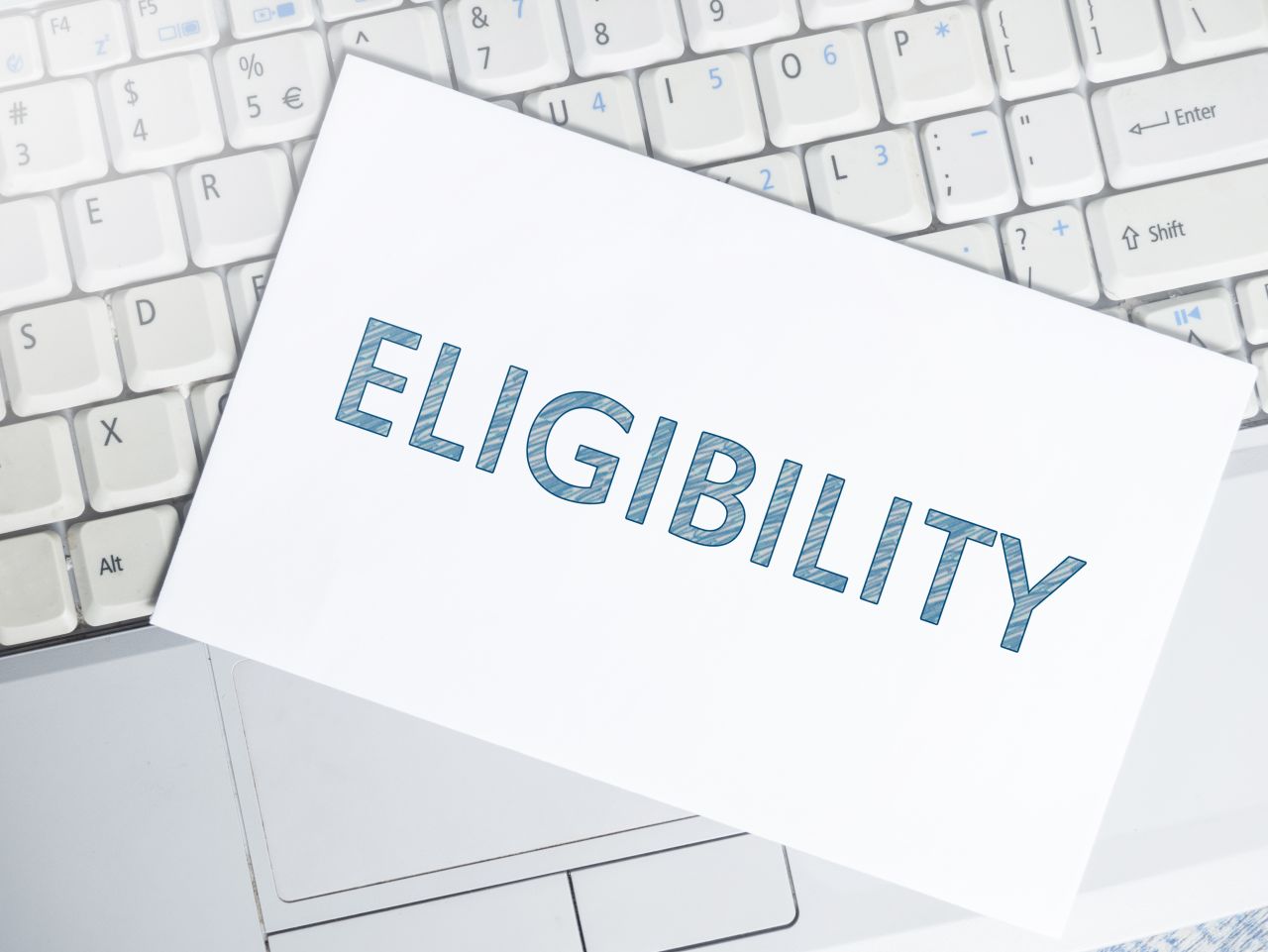 eligibility card on top of computer keyboard