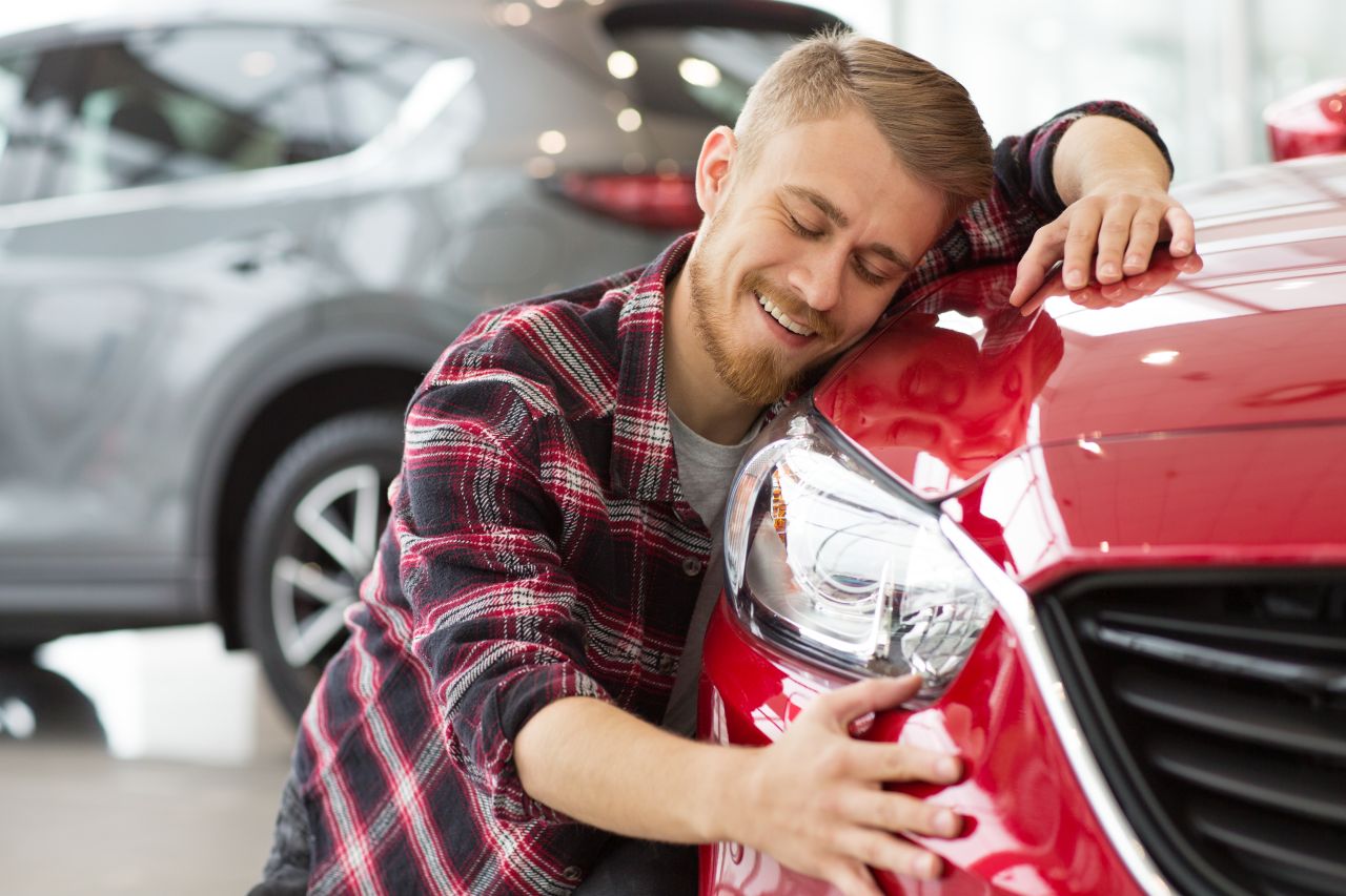 happy customer hugging his car