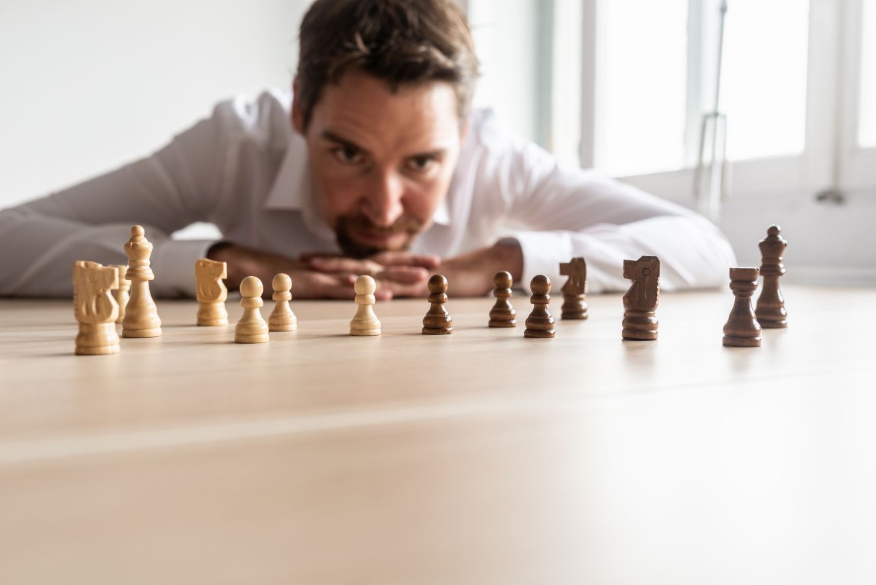 man playing chess strategizing next advertising move
