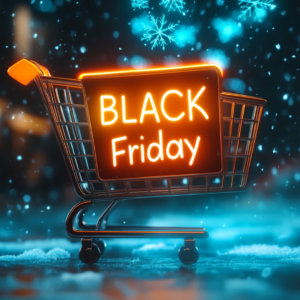 A shopping cart rests in the snow beneath a neon "Black Friday" sign, surrounded by snowflakes and soft, glowing lights, capturing the magic of the holiday retail season.