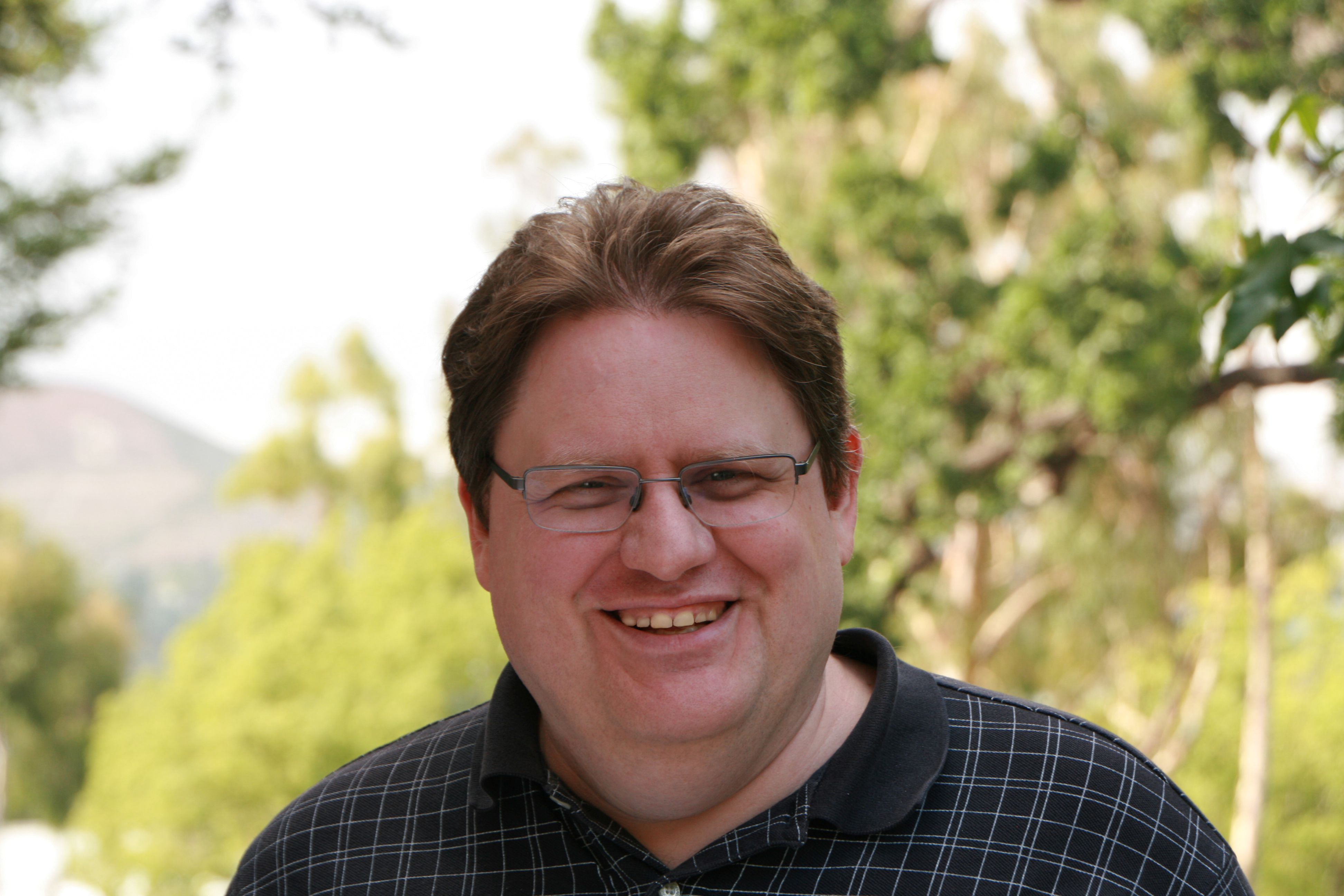 Meet the Team: A man wearing glasses and a black shirt.